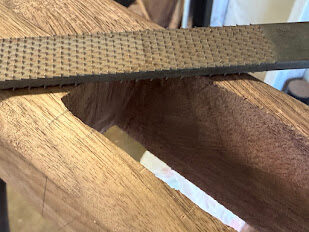 Rasp shaping a mortise in walnut